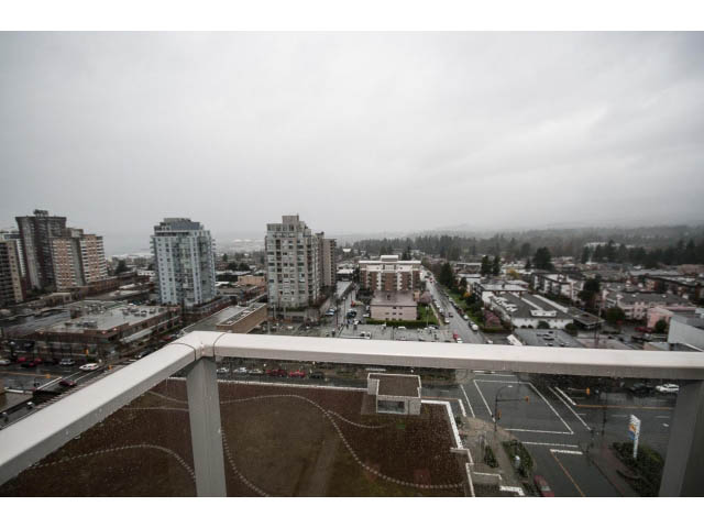 Bright living room with city view and modern furnishings. - 1602 - 135 East 17th Street, North Vancouver