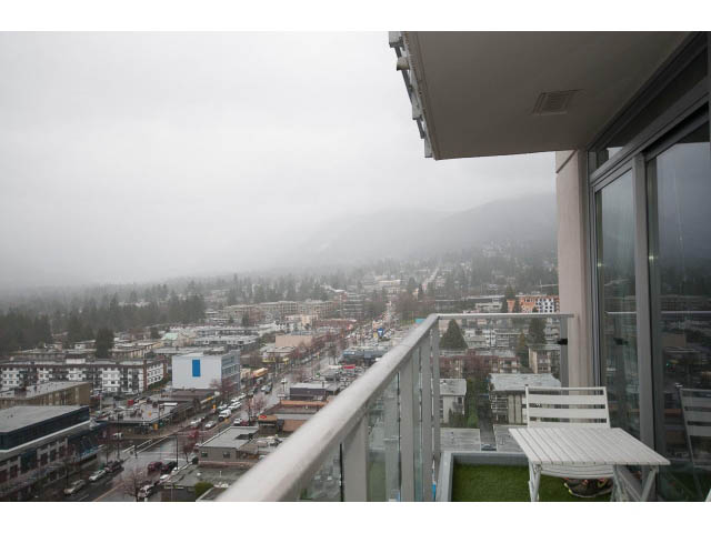 Balcony with city view and greenery, furnished seating. - 1602 - 135 East 17th Street, North Vancouver