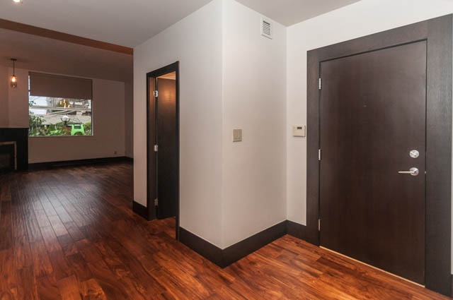 Bright living room with hardwood floors and a city view. - 102 - 1970 Haro St, Vancouver Downtown