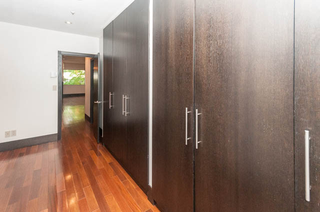 Furnished entryway with dark wood paneling and hardwood floors. - 102 - 1970 Haro St, Vancouver Downtown