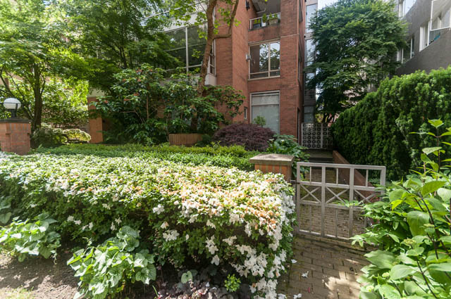 Furnished patio with lush greenery and blooming flowers. - 102 - 1970 Haro St, Vancouver Downtown