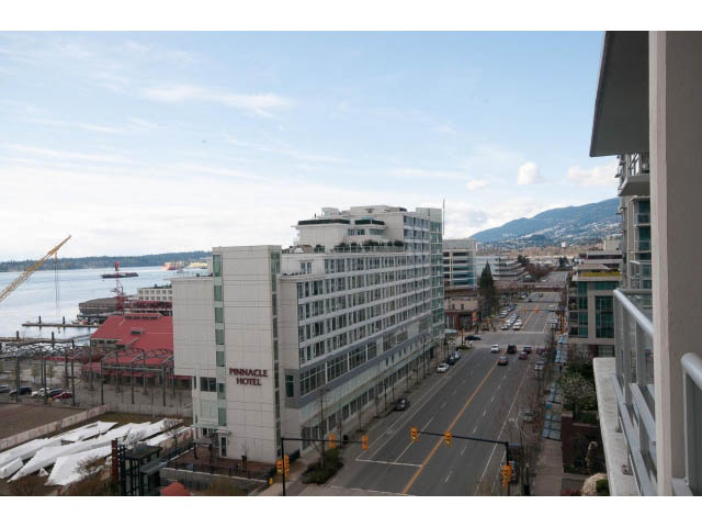 Bright living room with city view and modern furnishings. - 906 - 168 Esplanade, North Vancouver