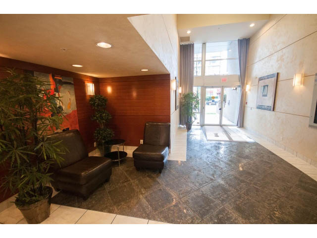 Furnished living room with dark marble flooring, modern furniture, and large windows. - 906 - 168 Esplanade, North Vancouver