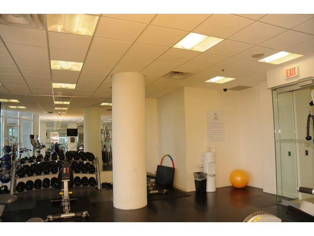Furnished gym with exercise equipment and mirrors. - 906 - 168 Esplanade, North Vancouver