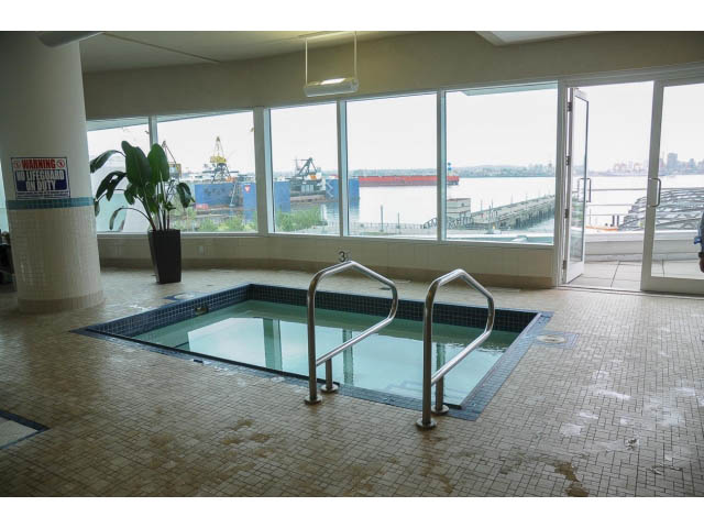 Spacious living room with large windows offering a stunning city view. - 906 - 168 Esplanade, North Vancouver