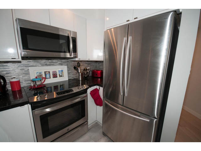Bright kitchen with stainless steel appliances, granite countertops, and hardwood floors. - 1502 - 907 Beach Ave, Vancouver Downtown