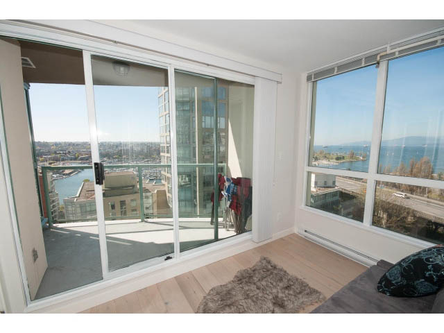 Spacious living room with hardwood floors, city view, and large windows. - 1502 - 907 Beach Ave, Vancouver Downtown