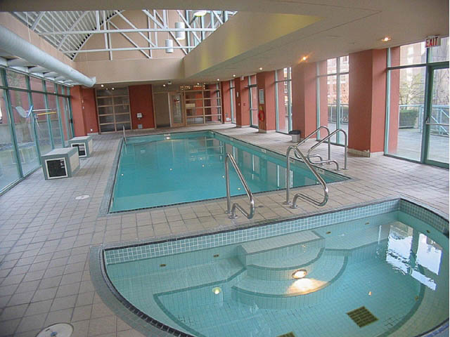Spacious indoor pool area with tiled floors and modern railings. - 1502 - 907 Beach Ave, Vancouver Downtown