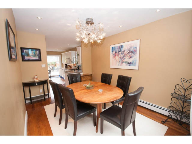 Furnished dining area with hardwood floors, chandelier, and artwork on the wall. - Main - 980 Montroyal Blvd, North Vancouver