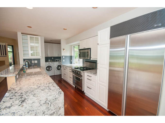 Bright kitchen with granite countertops, hardwood floors, and stainless steel appliances. - 3890 Sharon Drive, West Vancouver