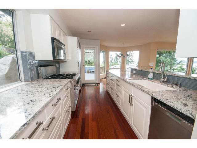 Bright kitchen with granite countertops, hardwood floors, and a city view. - 3890 Sharon Drive, West Vancouver