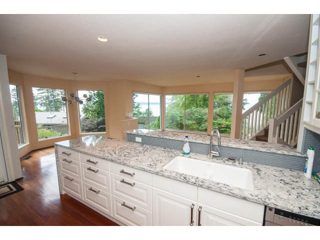 Bright kitchen with granite countertops, hardwood floors, and a city view. - 3890 Sharon Drive, West Vancouver