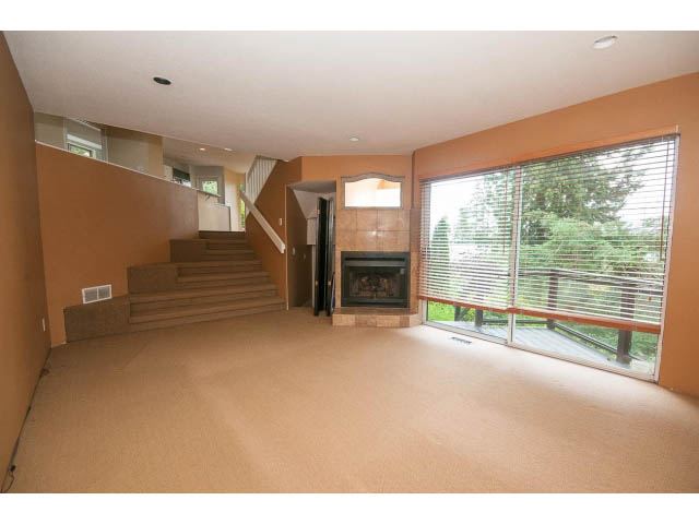 Open-concept living area with stairs, large windows, and natural light. - 3890 Sharon Drive, West Vancouver