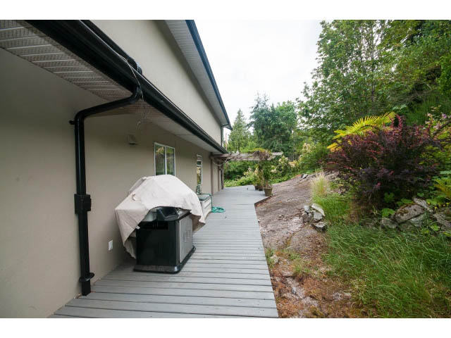 Deck area with outdoor furniture and garden view. - 3890 Sharon Drive, West Vancouver