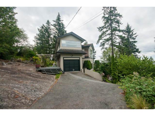 Furnished 3-bedroom house with a modern design, large windows, and a stone driveway leading up to the entrance. - 3890 Sharon Drive, West Vancouver