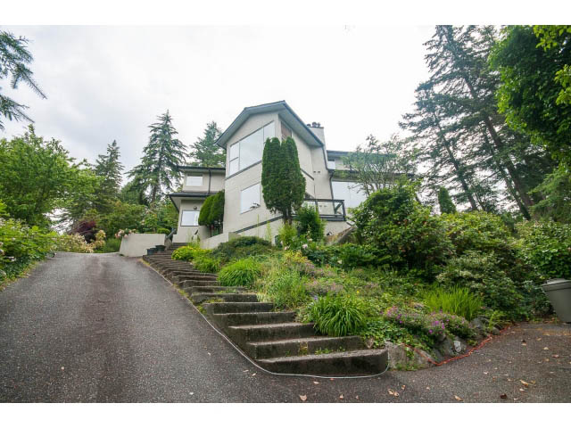 Staircase leading to a 3-bedroom house with lush greenery and a modern design. - 3890 Sharon Drive, West Vancouver