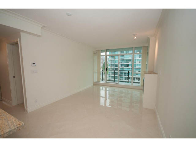 Bright living room with city view and marble countertops. - 1101 - 172 Victory Ship Way, North Vancouver