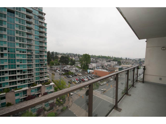 Furnished balcony with city view and modern railings. - 1101 - 172 Victory Ship Way, North Vancouver