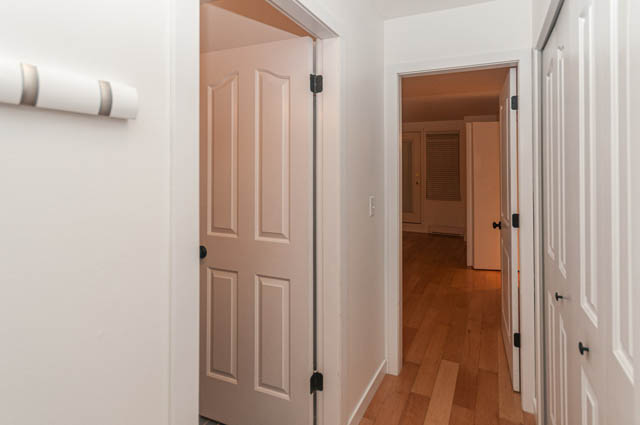 Furnished entryway with hardwood floors and white doors leading to other rooms. - 2263 Heather st., Vancouver West Side