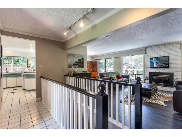 Open-concept living space with tiled floors and a view of the kitchen. - 3243 Milton Ave., North Vancouver