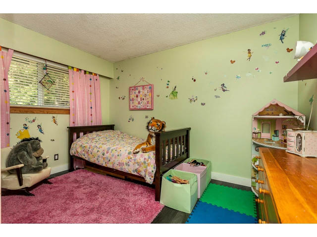 Bright bedroom with pink carpet, bunk beds, and colorful wall decorations. - 3243 Milton Ave., North Vancouver