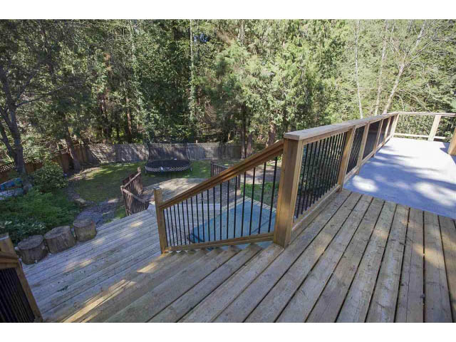 Spacious deck with wooden railings and forest view. - 3243 Milton Ave., North Vancouver