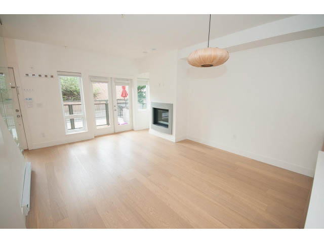 Spacious living room with hardwood floors and modern lighting. - 3187 St. George St., Vancouver East Side