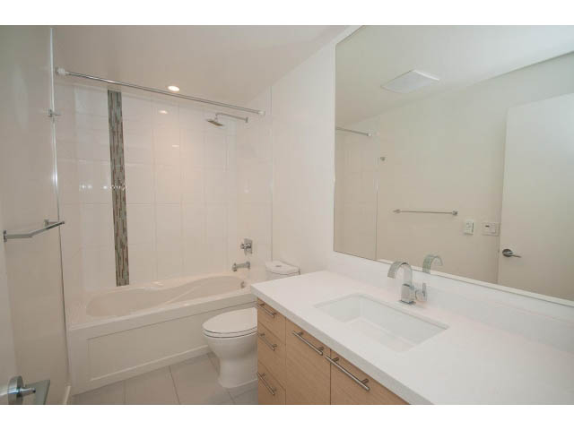 Bright bathroom with white countertops and a walk-in shower. - 3187 St. George St., Vancouver East Side