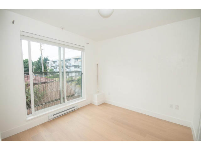 Bright living room with hardwood floors and city view. - 3187 St. George St., Vancouver East Side