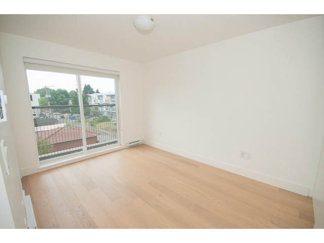 Bright living room with hardwood floors and city view. - 3187 St. George St., Vancouver East Side
