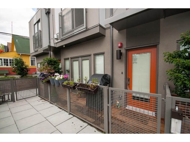 Furnished patio with metal fencing and potted plants. - 3187 St. George St., Vancouver East Side