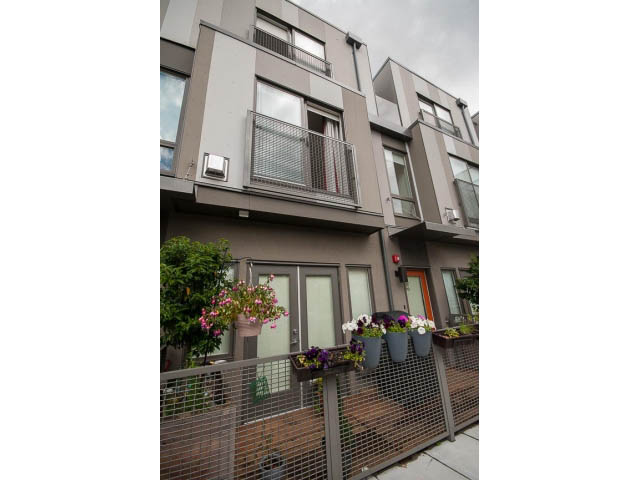 Furnished 2-bedroom townhouse with modern balcony and hanging flowers. - 3187 St. George St., Vancouver East Side