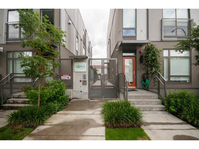 Furnished 2-bedroom townhouse with modern exterior, steps leading to entrance, and greenery. - 3187 St. George St., Vancouver East Side
