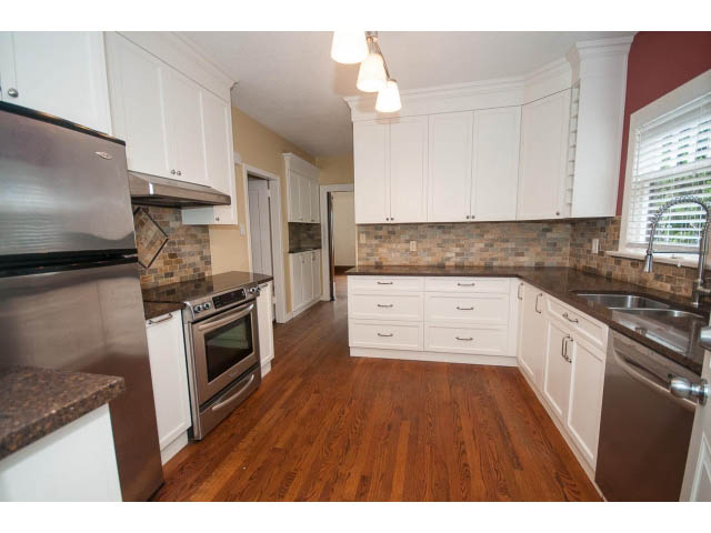 Bright kitchen with granite countertops, hardwood floors, and stainless steel appliances. - 5756 Angus Drive, Vancouver West Side