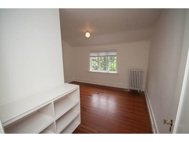 Bright den with hardwood floors and built-in shelves, natural light from windows. - 5756 Angus Drive, Vancouver West Side