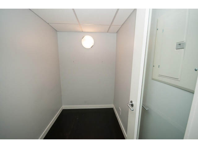 Bright hallway with dark flooring and white walls, leading to a den area. - 1106 - 788 Richards, Vancouver Downtown