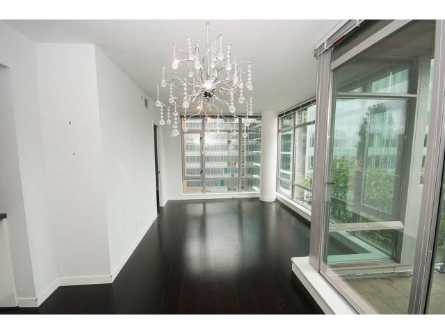 Spacious living room with hardwood floors, large windows, and a chandelier. - 1106 - 788 Richards, Vancouver Downtown