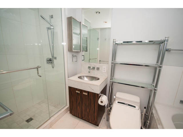 Furnished bathroom with modern fixtures, glass shower, and wooden vanity. - 1106 - 788 Richards, Vancouver Downtown