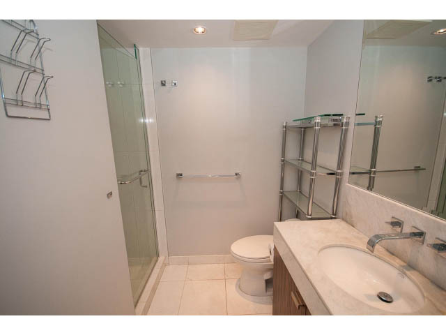 Bright bathroom with modern sink, large mirror, and glass shower. - 1106 - 788 Richards, Vancouver Downtown