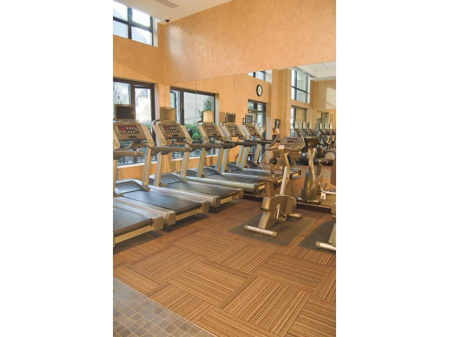 Spacious gym with wooden flooring and cardio equipment. - 1106 - 788 Richards, Vancouver Downtown