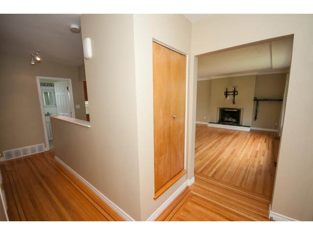 Bright living room with hardwood floors and a fireplace. - 549 W Queens, North Vancouver