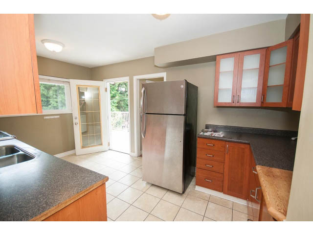 Bright kitchen with granite countertops, stainless steel appliances, and a city view. - 549 W Queens, North Vancouver