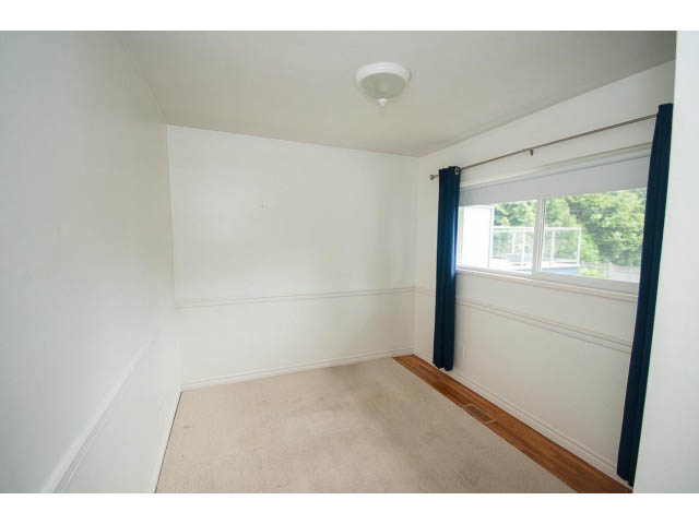 Bright bedroom with hardwood floors and large windows. - 549 W Queens, North Vancouver