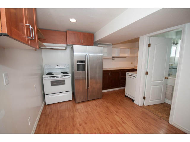 Bright kitchen with stainless steel appliances and hardwood floors. - 549 W Queens, North Vancouver
