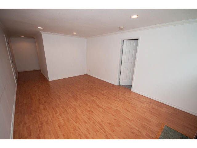 Bright living room with hardwood floors and white walls. - 549 W Queens, North Vancouver