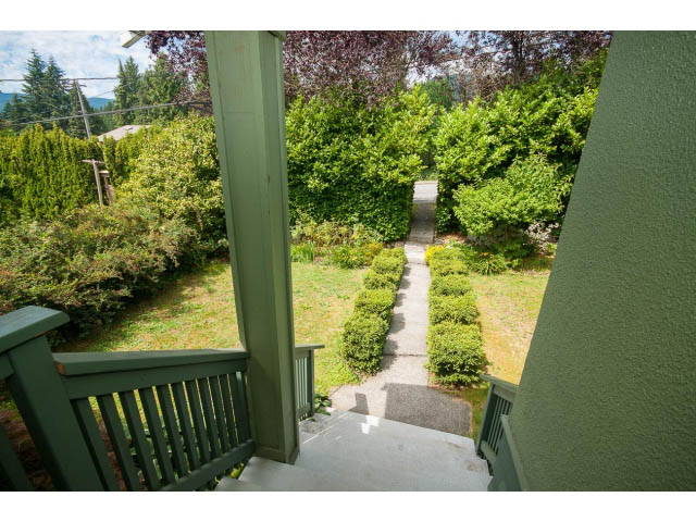Staircase leading to a lush garden with greenery and trees. - 549 W Queens, North Vancouver