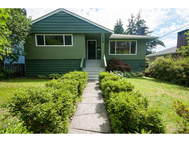 Furnished 5-bedroom house with green siding and a welcoming front porch. - 549 W Queens, North Vancouver