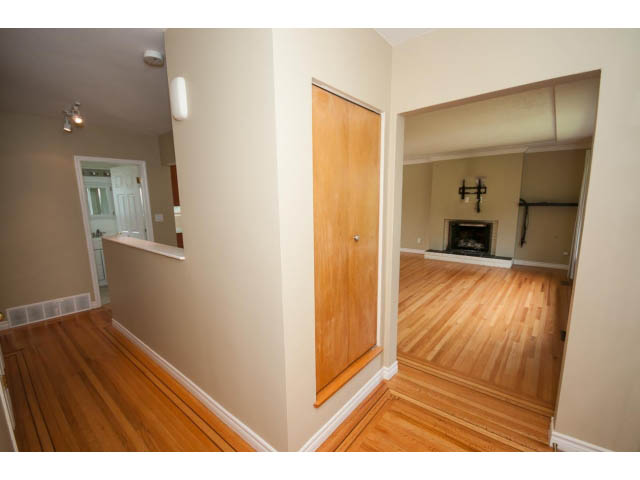 Bright living room with hardwood floors and a cozy fireplace. - 549 W Queens, North Vancouver