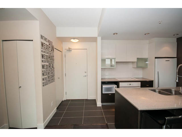 Bright kitchen with granite countertops and white cabinets, modern design. - 1105 - 175 West 2nd Street, North Vancouver