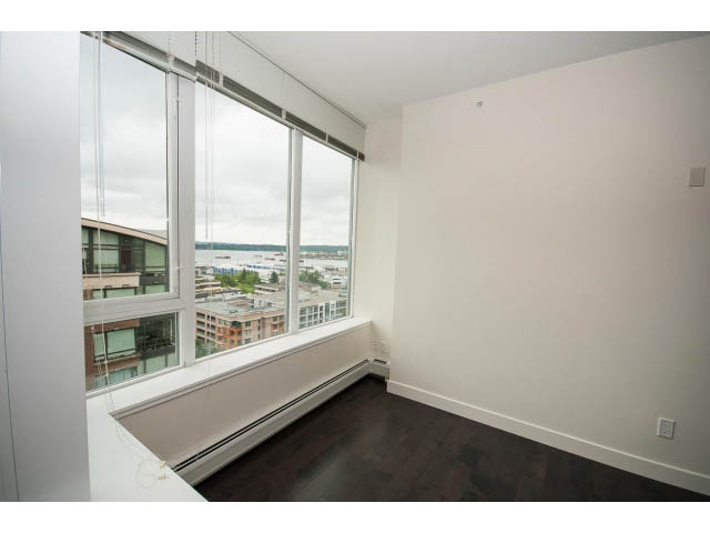 Bright living room with hardwood floors and city view. - 1105 - 175 West 2nd Street, North Vancouver